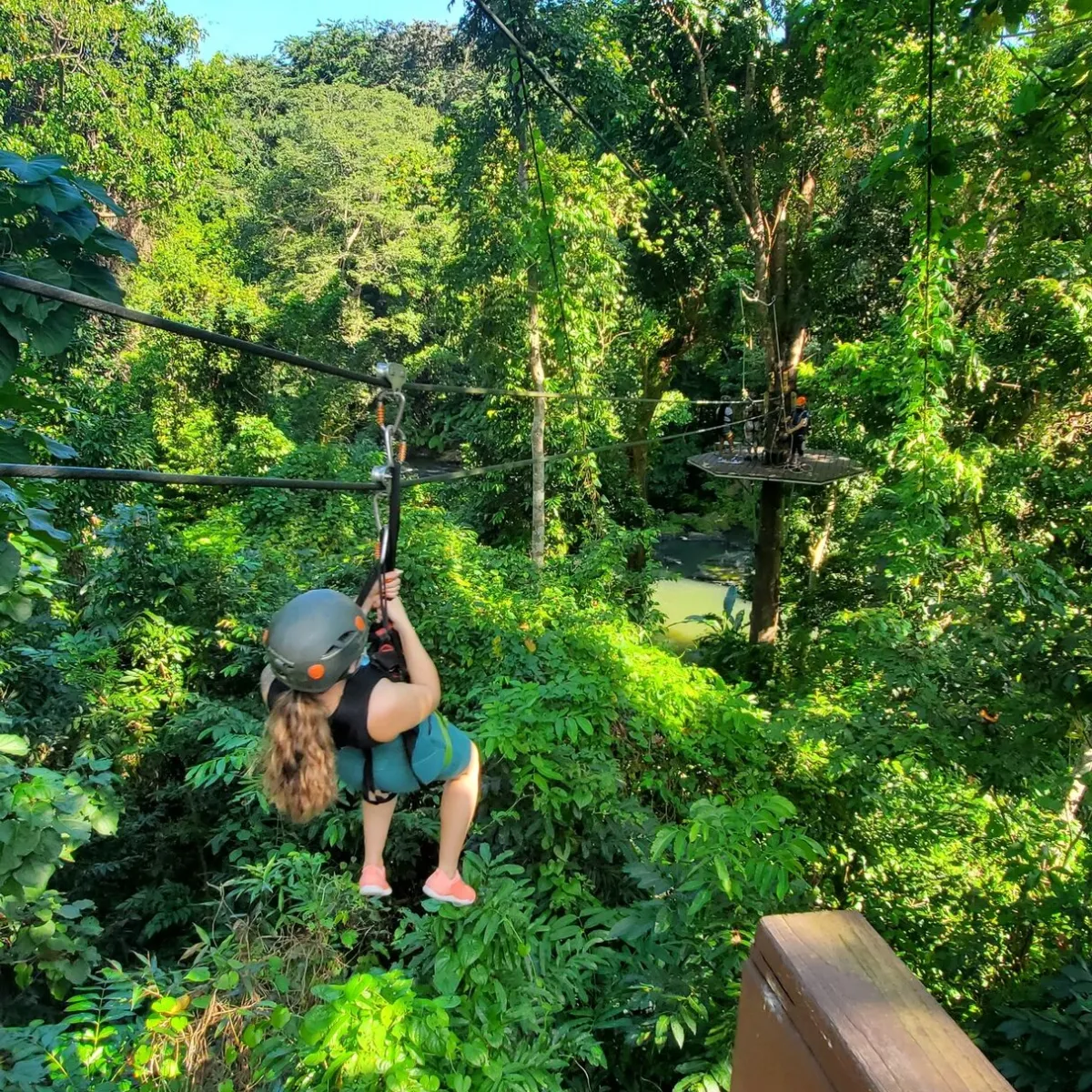 a man standing next to a tree